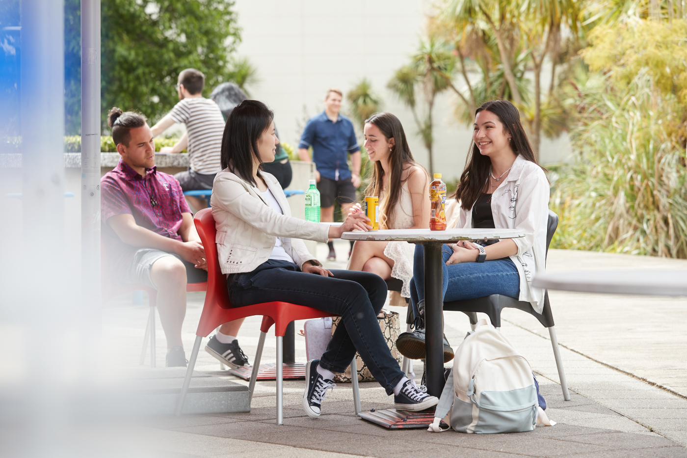 students-sitting-around-cafe-table