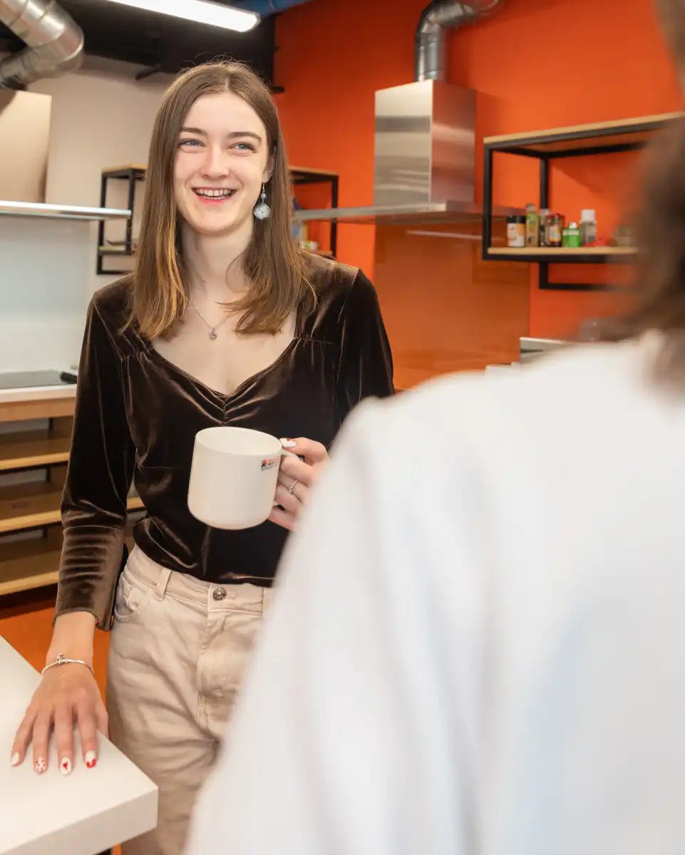 student having coffee in kitchen