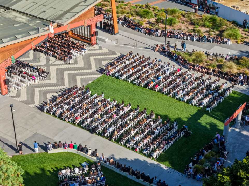 Attendees at the new student pōwhiri gather outside The Pā