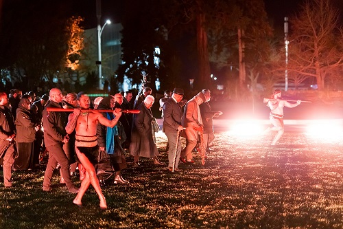 Maori dance being performed at night. 