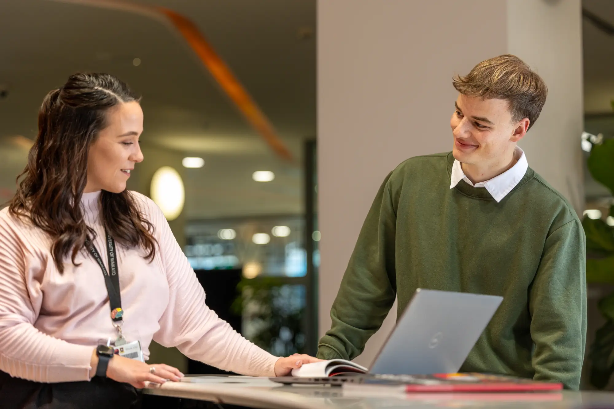 student-advisor-assisting-student-smiling