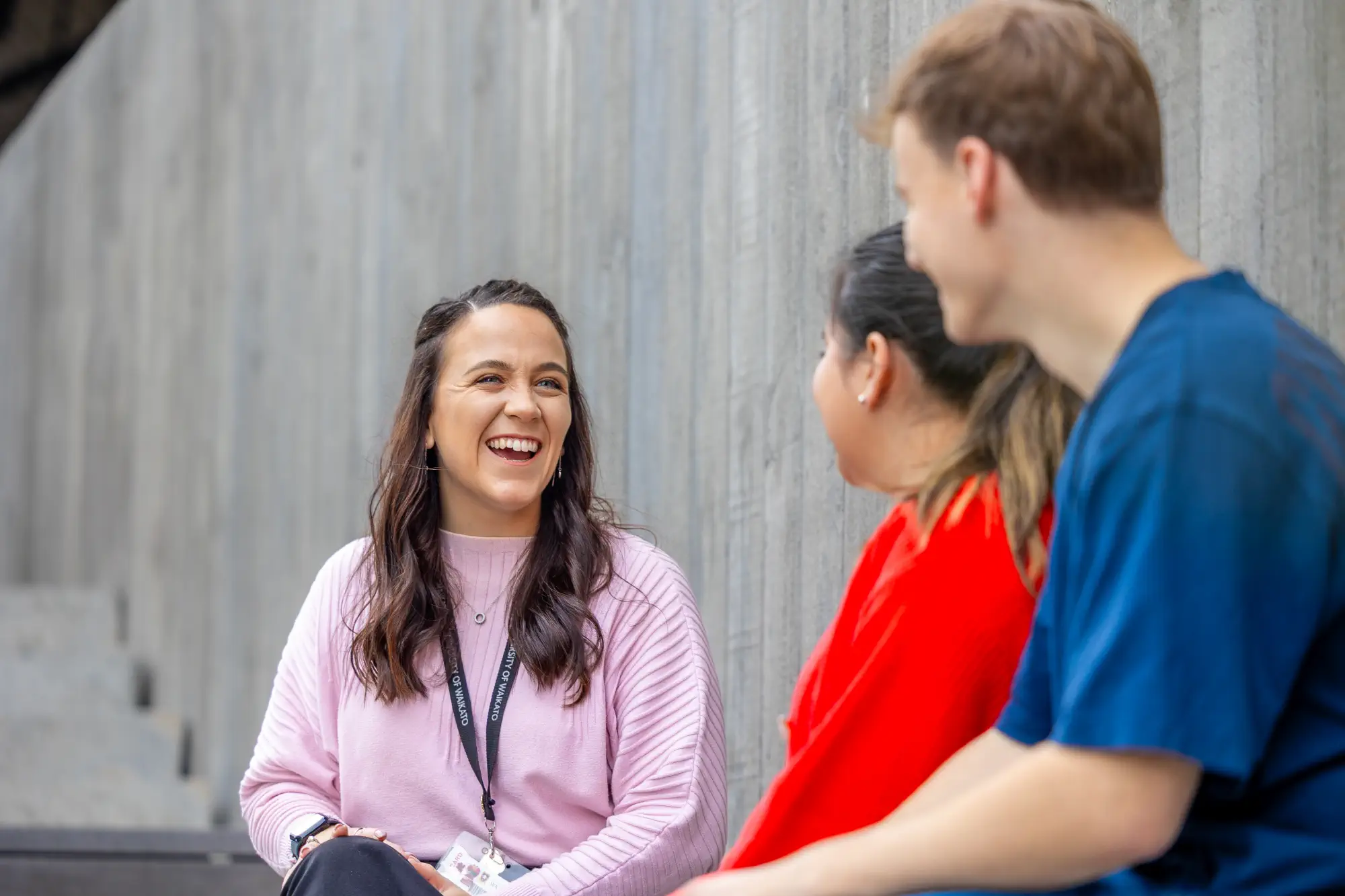 student-advisor-sitting-outside-with-students