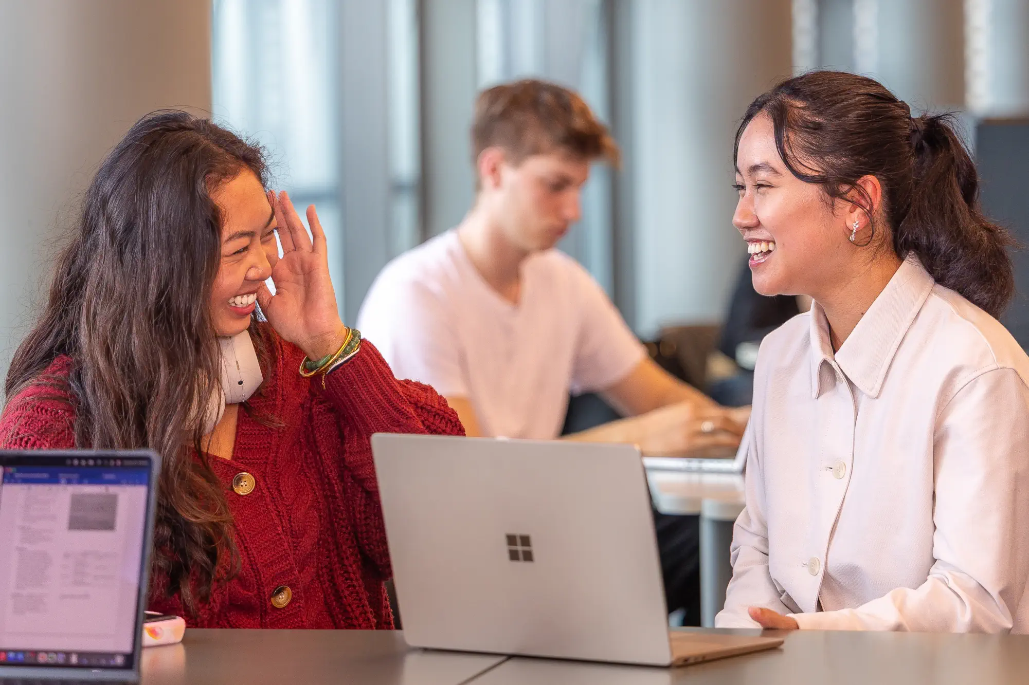 two-students-laughing-at-desk