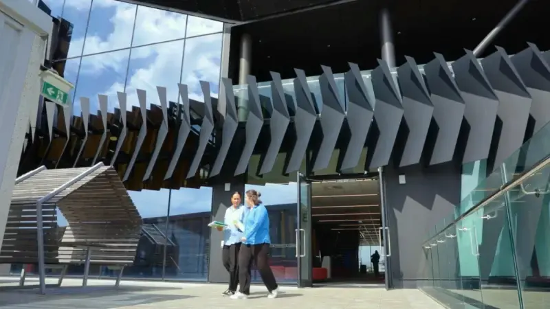 woman walking out of building (1)